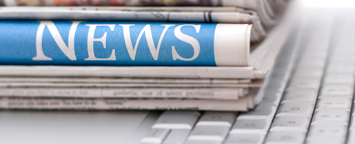 Stack of newspapers on top of a keyboard