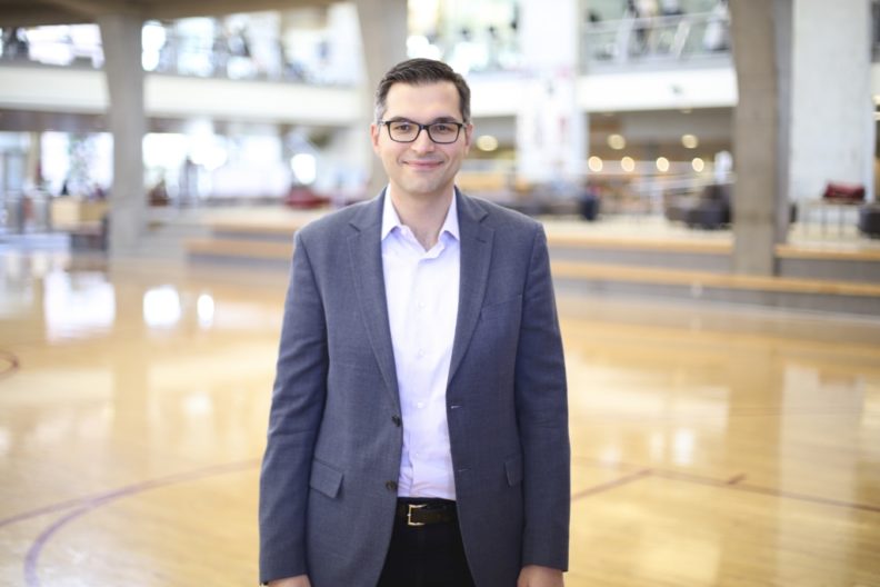 Medium shot of Simon Licen over a generic sports/recreation background