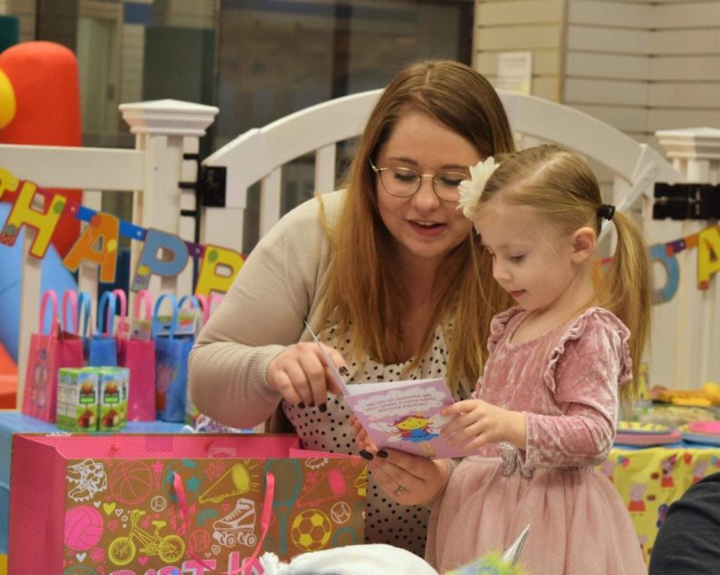 Samantha Brosnan reading to her young daughter.