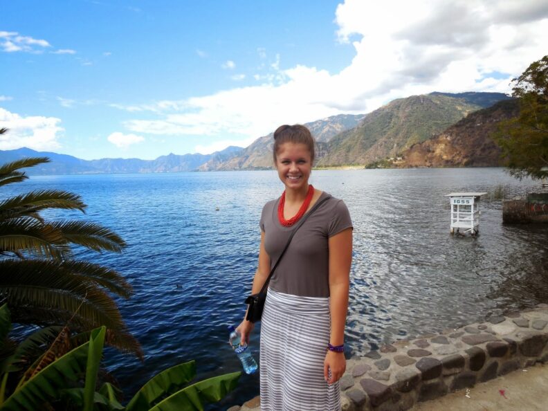 Maren Talcott, in front of Lake Atitlan, smiling at camera.
