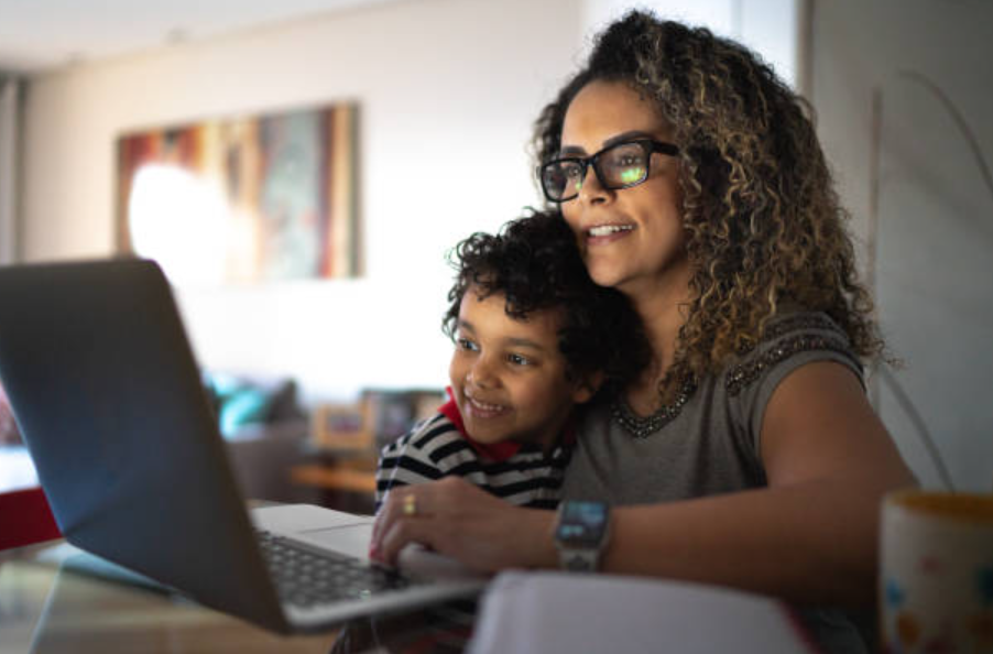 Mother and son at computer working