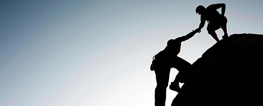 two individual climbing a hill