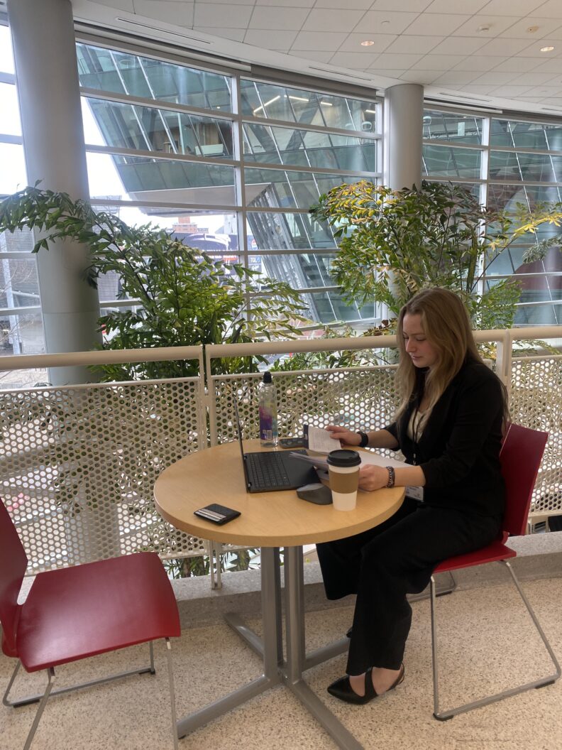 Sadie Chamberlain sitting at a table preparing her presentation.
