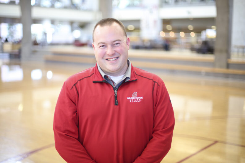 WSU faculty member DJ Mackie smiling at camera.