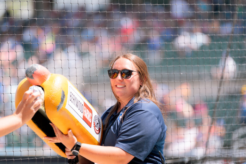 Kinsey Kallahar gets set to shoot hot dogs into the crowd at an Iowa Cubs Minor League Baseball game.