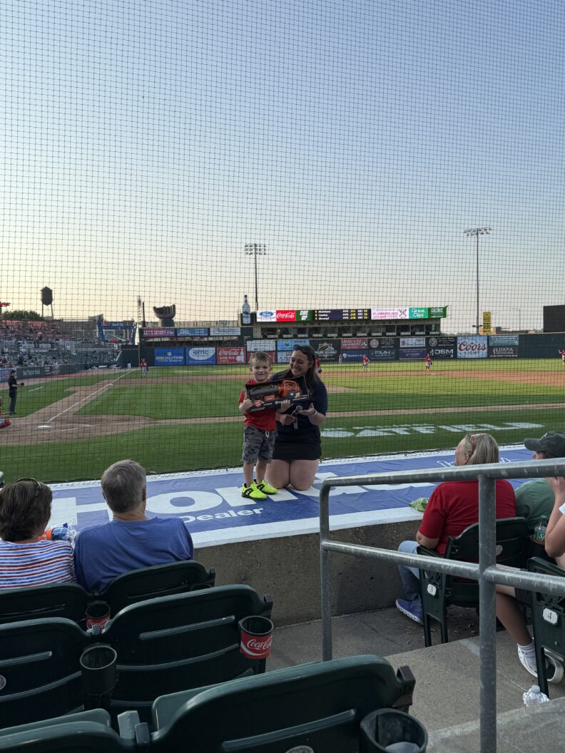 For completing the interview in front of thousands of fans, Kinsey presents the young fan with a toy.