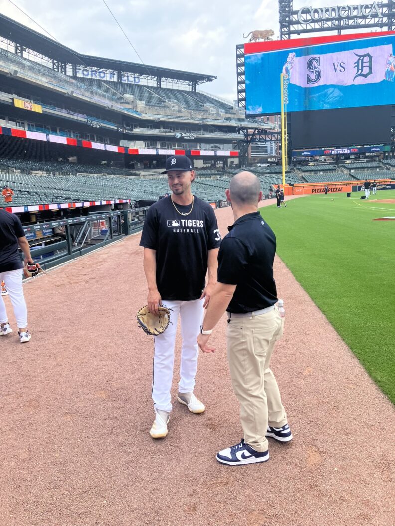 Colin talking to a player (Zach McKinstry) during batting practice.