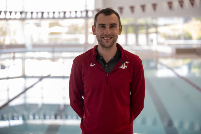 Jared Lindorfer smiling at camera in front of pool