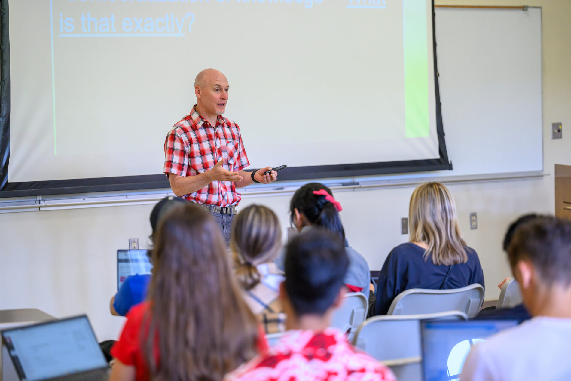 Instructor giving a presentation to students in a classroom.