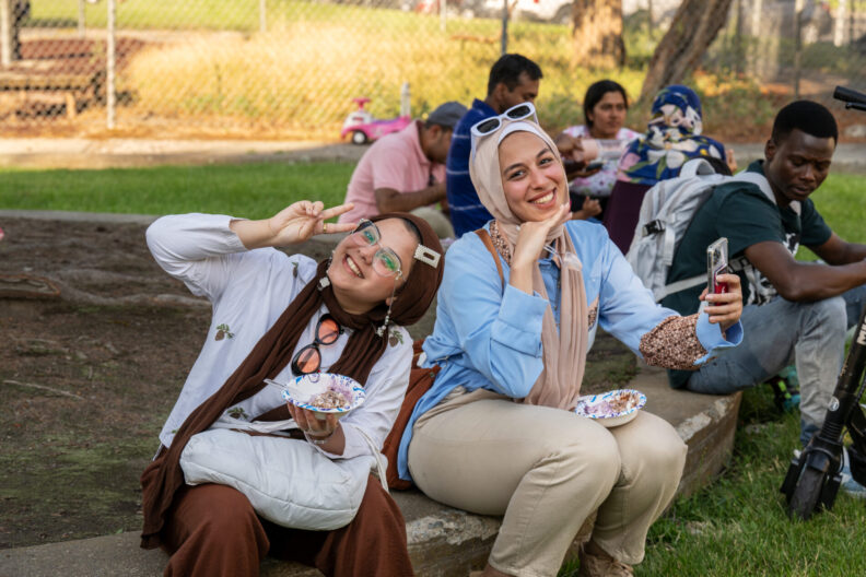 Two Washington State University international students have fun during the International Students Ice Cream Social, Friday, July 19, 2024, at the WSU-owned Terrace Apartments in Pullman.