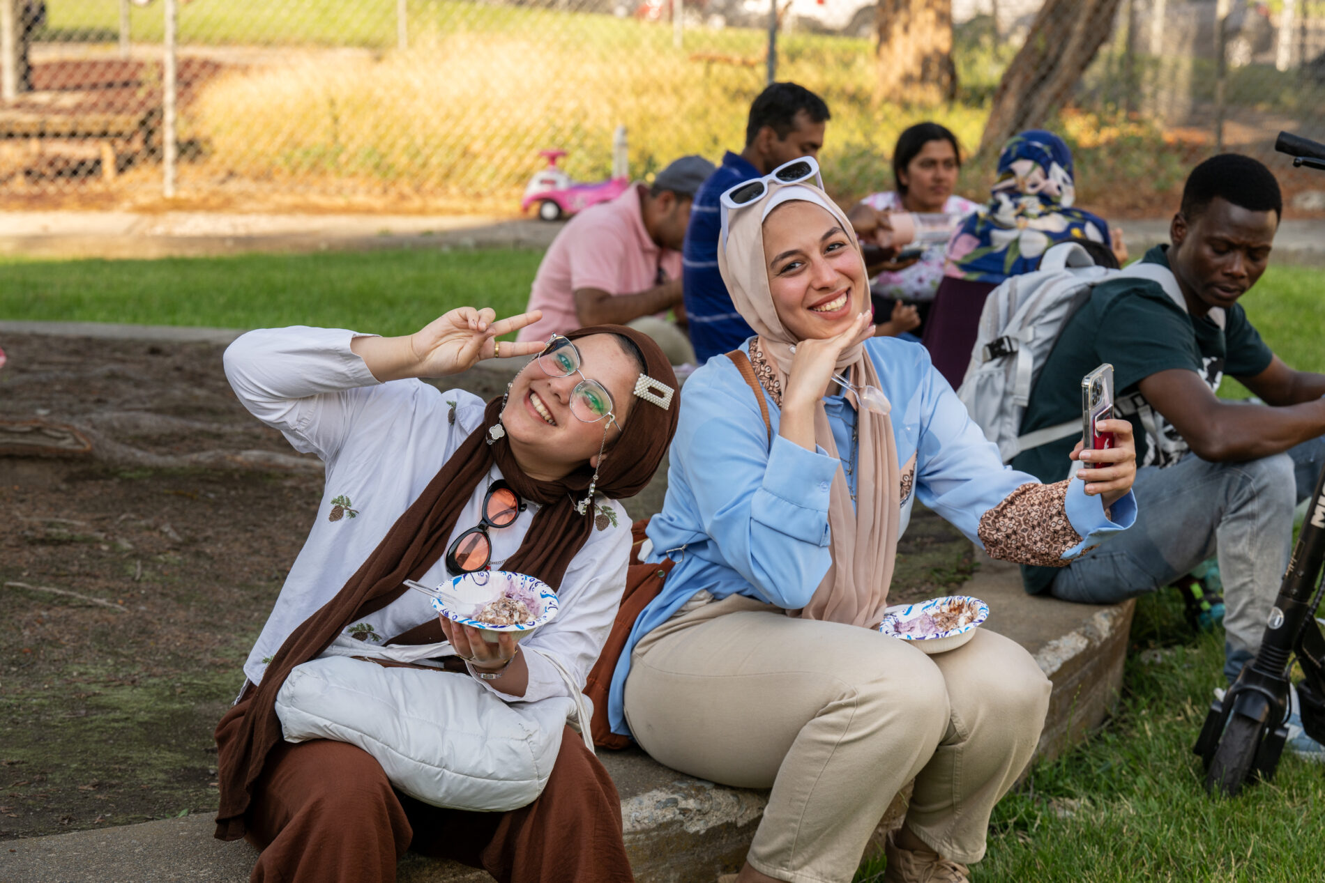 Two Washington State University international students have fun during the International Students Ice Cream Social, Friday, July 19, 2024, at the WSU-owned Terrace Apartments in Pullman.