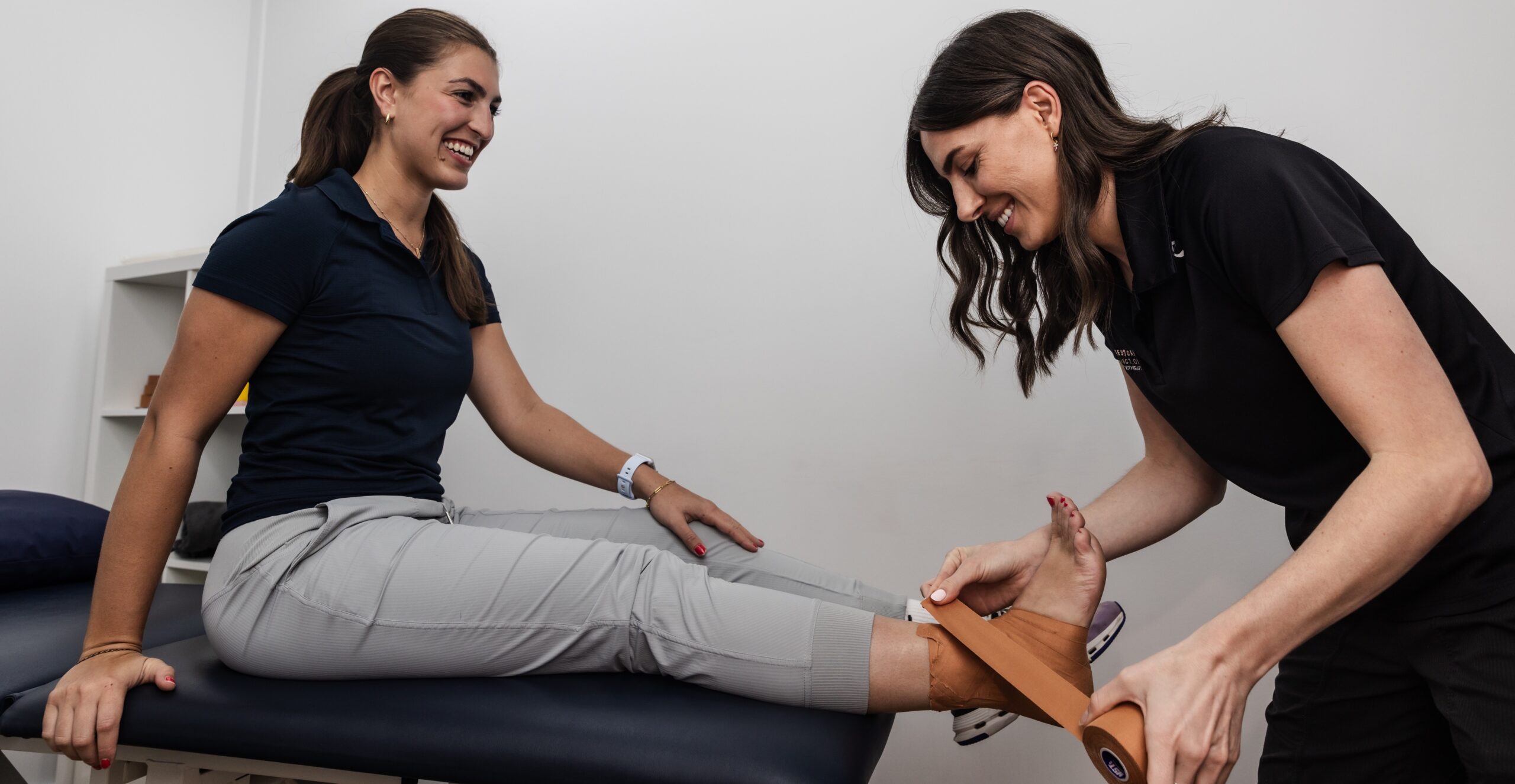 student wrapping feet