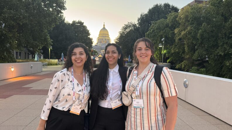 three students in front of Wisconsin state house