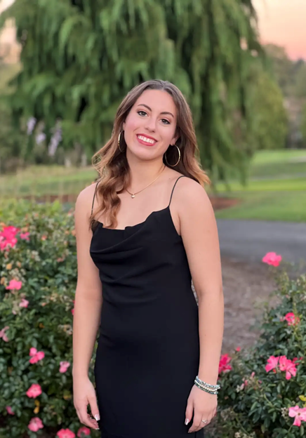 Abigail standing in a graden