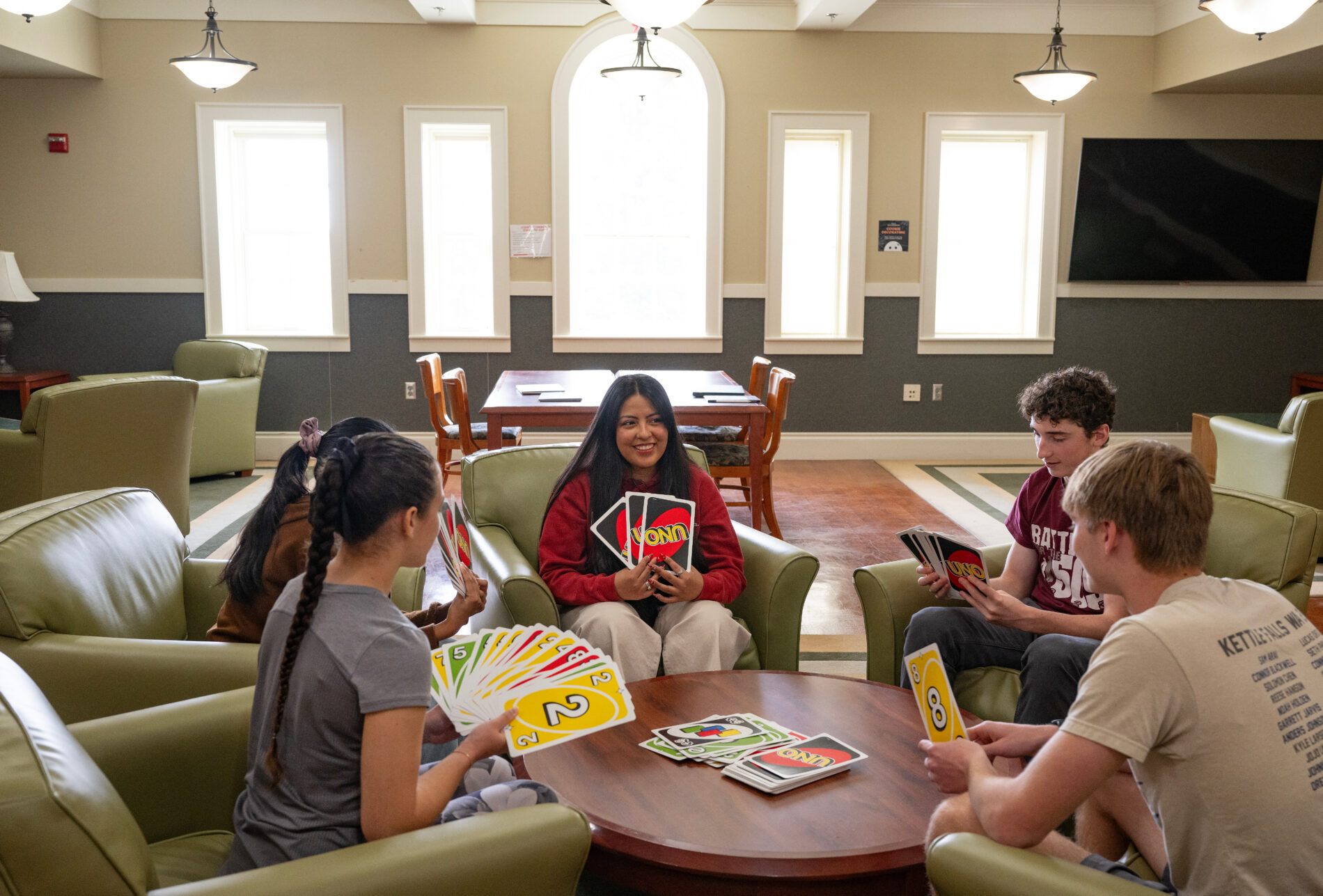 Residents of Honors Hall play a game in the lounge on the campus