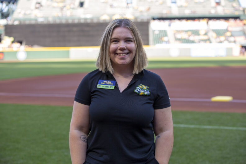 Aidan Matthews smiling at the camera from the field at T-Mobile Park.