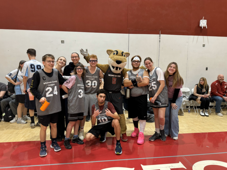 ROAR students participating in a Special Olympics Basketball game with Butch T. Cougar