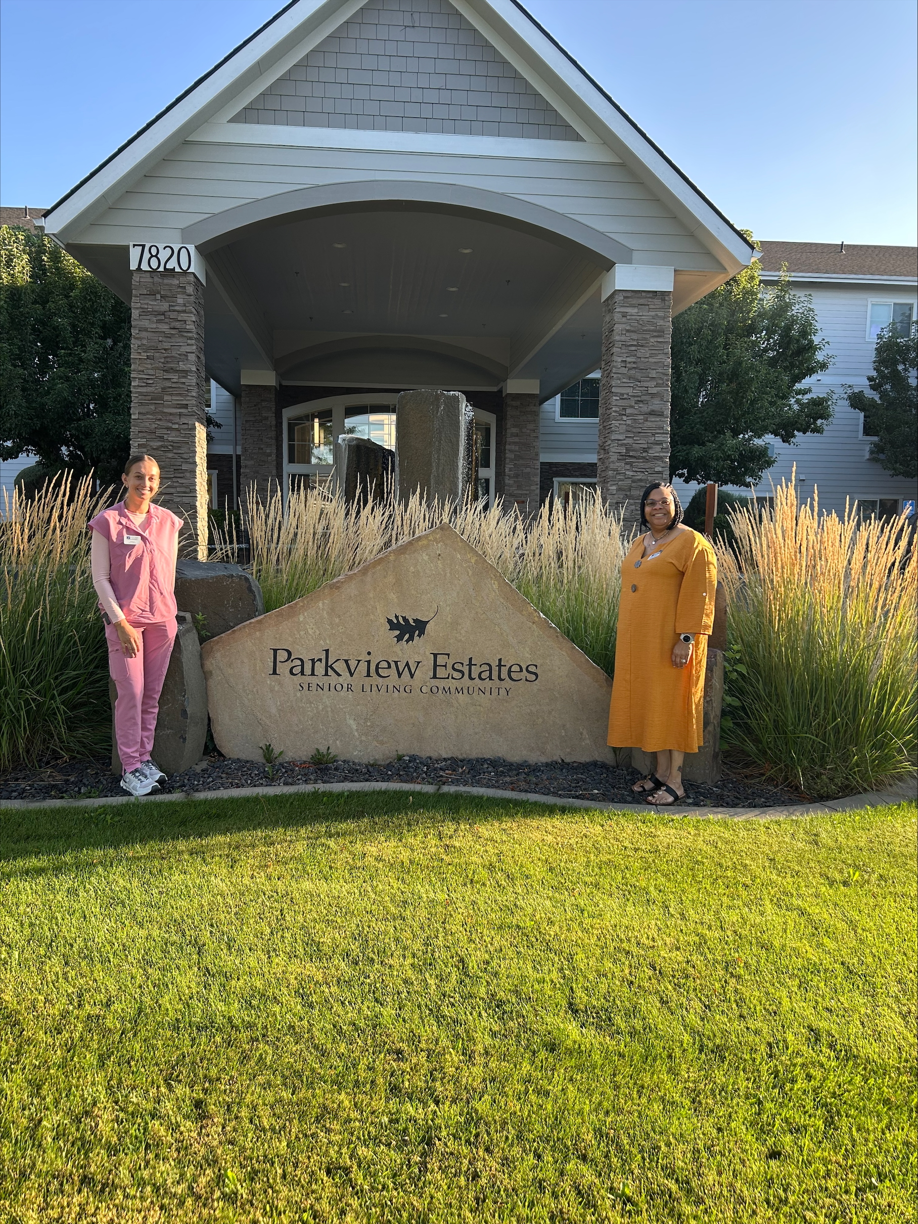 two ladies standing beside Parkview Estates sign