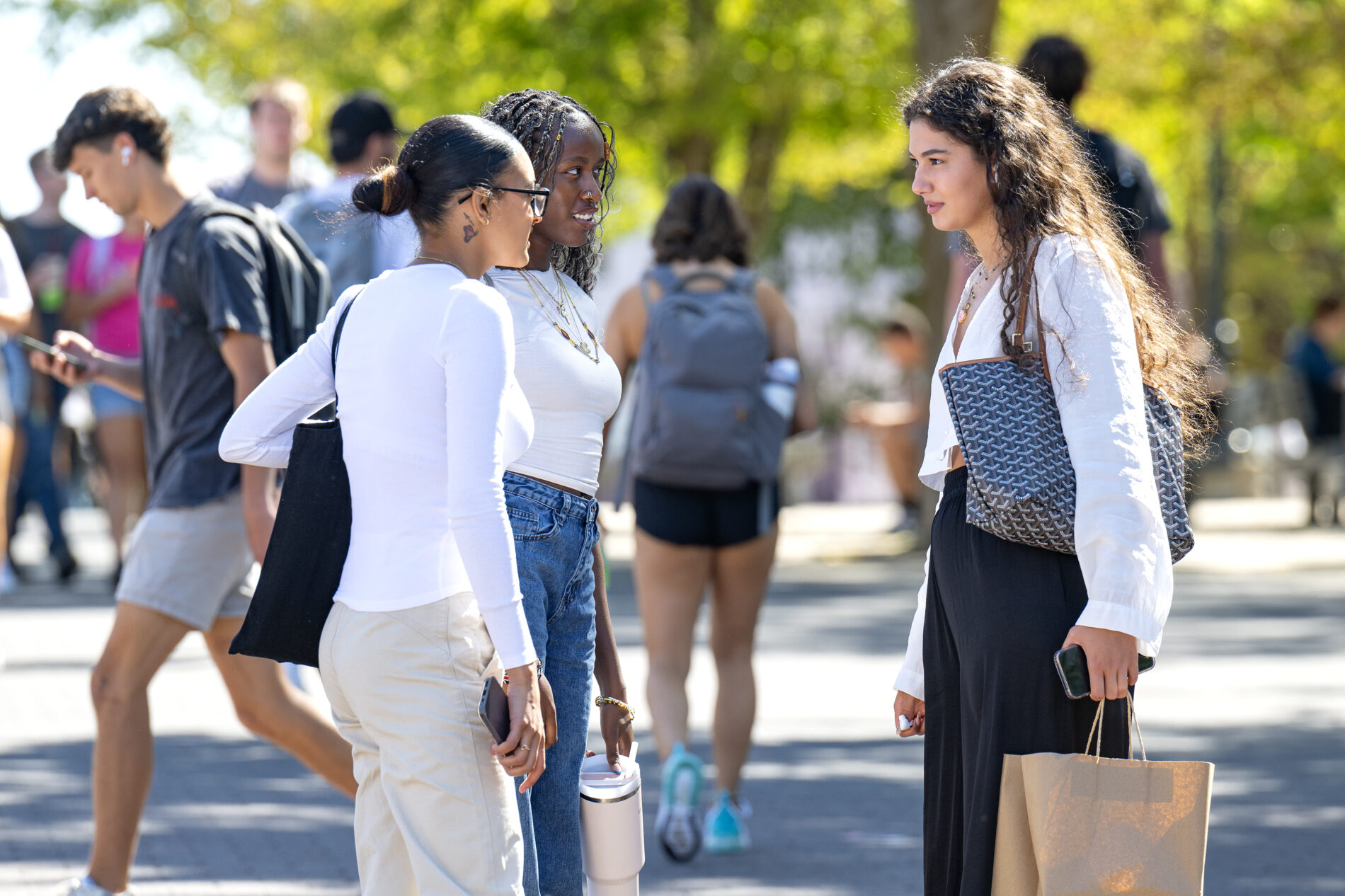 Three girls talking during Class change fall semester on the campus
