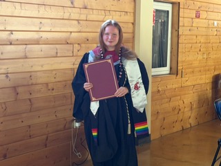 ROAR student standing with award