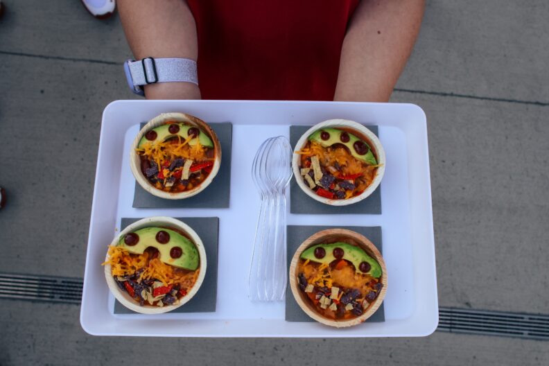 A student displays dishes prepared by WSU ROAR students and WSU Baseball Players