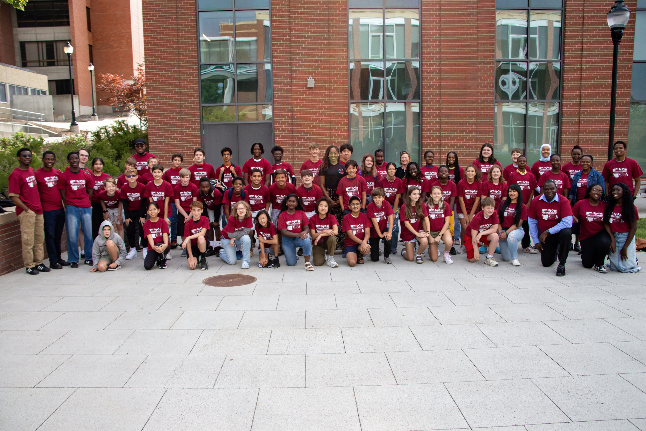 Programming Camp participants, instructors, CESHS dean, and CESHS development director, smiling at camera.