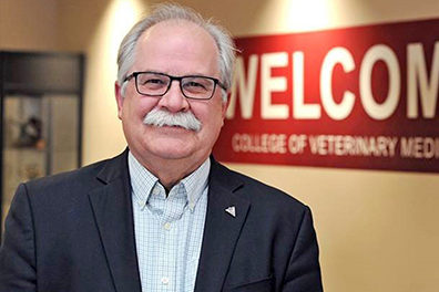 Bryan Slinker smiling at camera, mustache on point.