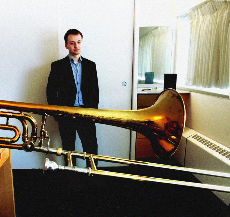 A photo of Jacob Zollers and a trombone