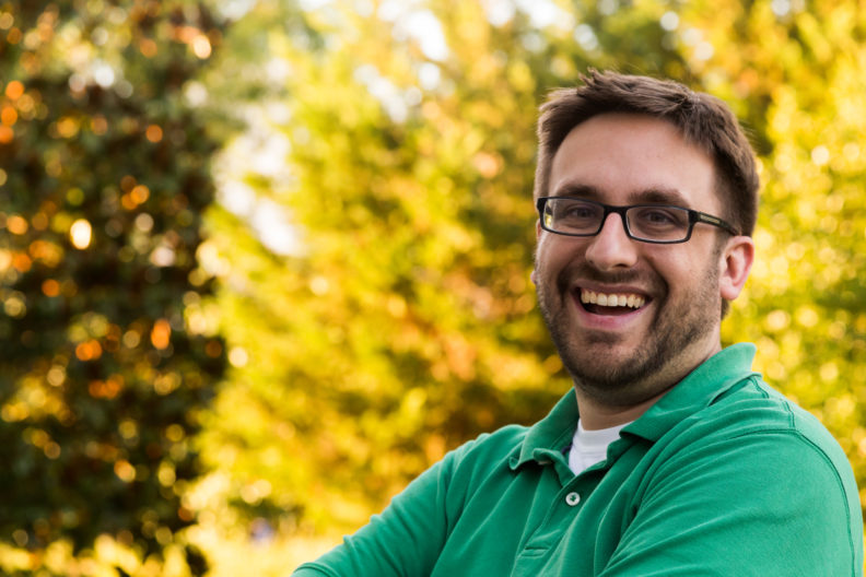 Man smiling in green polo