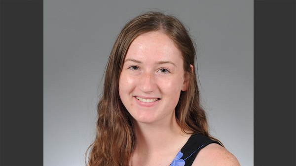 Brietta in a photo studio (grey background).