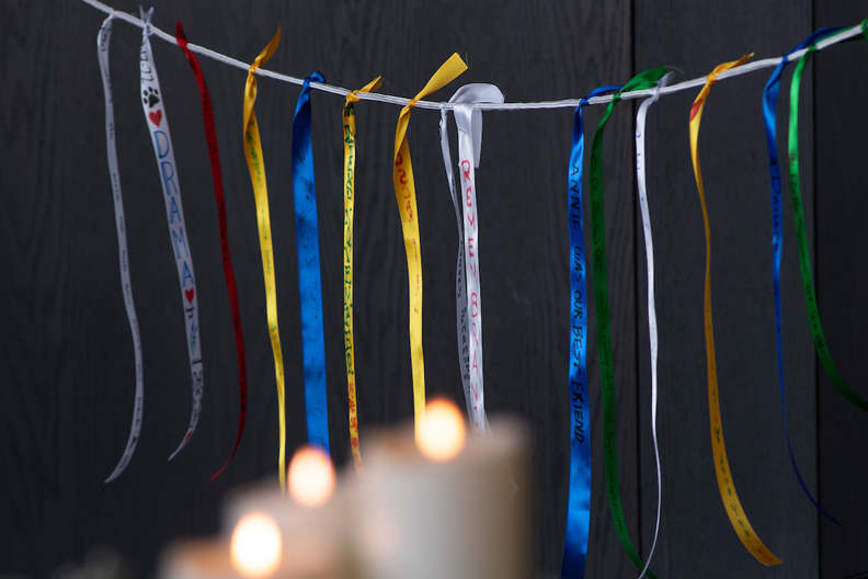 Remembrance ribbons with candles burning in the foreground.