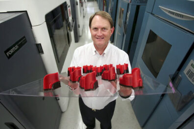 Scott is holding up 3D Printed samples