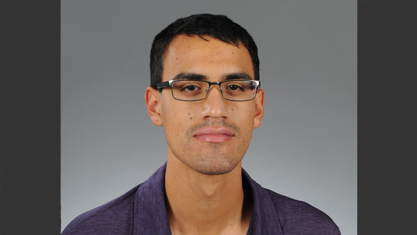 Professional headshot of Kevin in a photo studio.