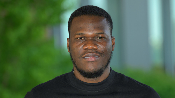 Professional headshot of Victor. He is wearing a black shirt.