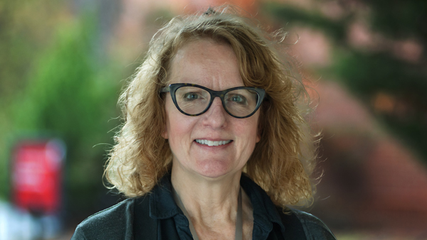 Dr. Kline, outside the Teaching Hospital. She is wearing a black top.