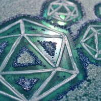 Close-up of an artistic pattern resembling 20-sided dice (icosahedrons) outlined in pearlescent white on a textured teal and blue surface. The design has a glossy, iridescent quality with clusters of raised blue dots and shimmering highlights.