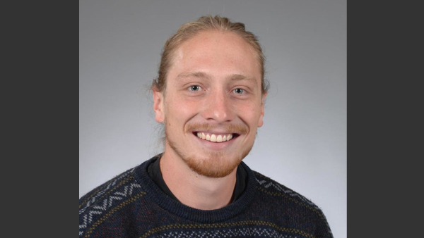 Steven in a photo studio. He's wearing a dark shirt.