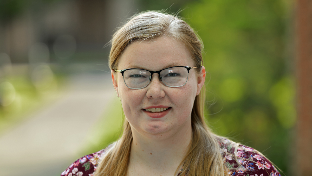 Marika outside, wearing a patterned top.
