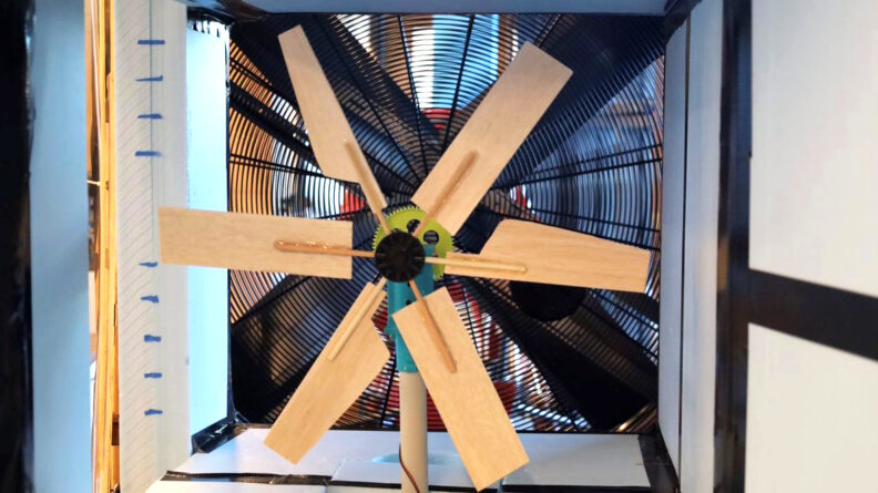 A wooden fan mounted in a frame.