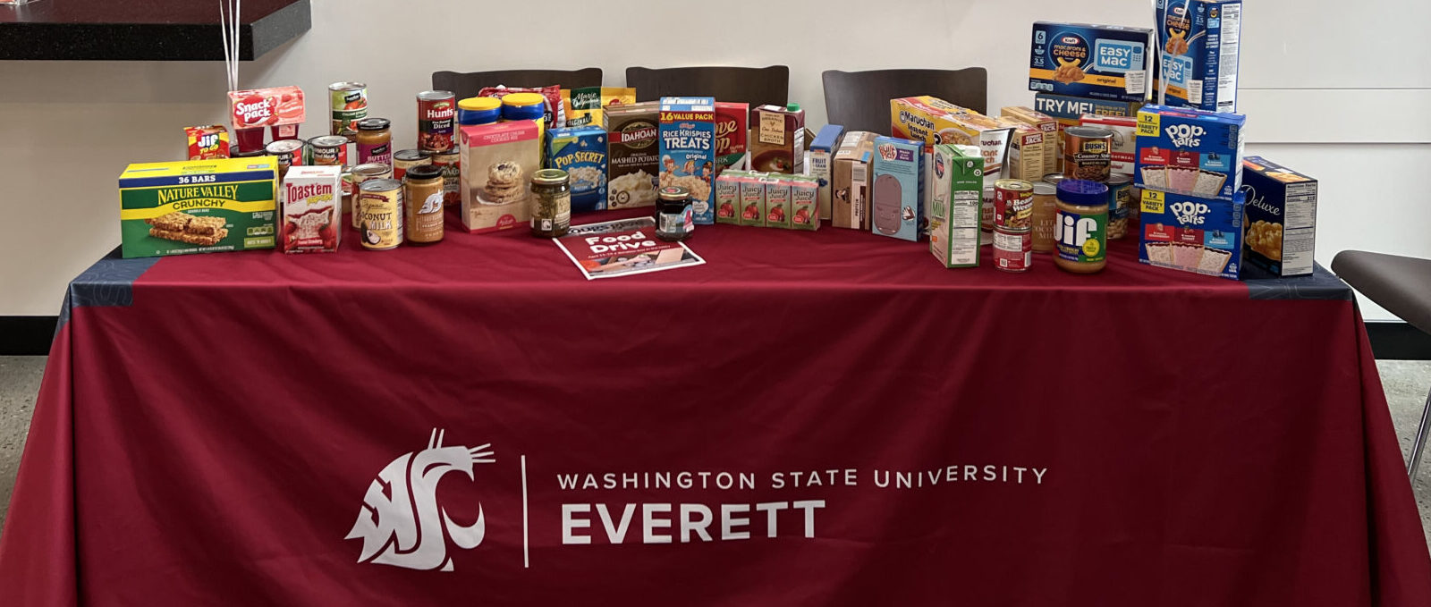 Closeup of a person wearing a college graduation hat with a cougar logo.