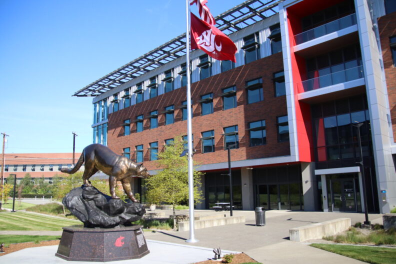 An academic building on the WSU Everett campus with a statue of a cougar.