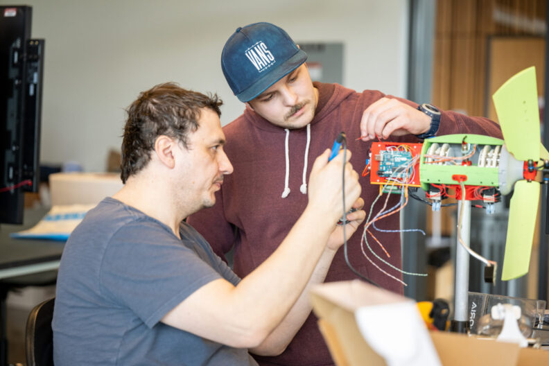 Two students working on an electrical project.