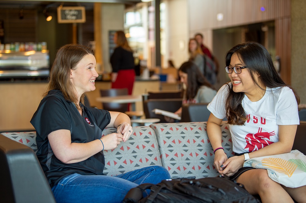 Two students talking in a common area.