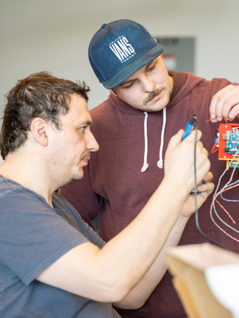 Two students working on an electrical project.