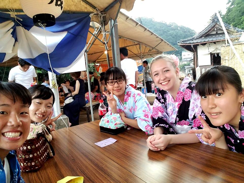 Picture of smiling exchange students around a table