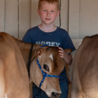Boy and his cow at fair.
