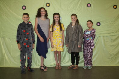 Group of five youth model their fashion revue entries.