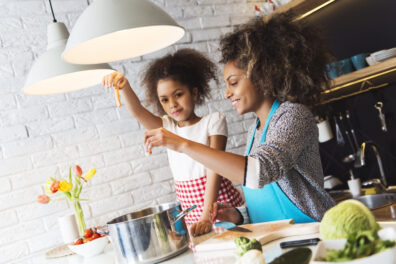 African American woman and her daughter cooking in the kitchen
