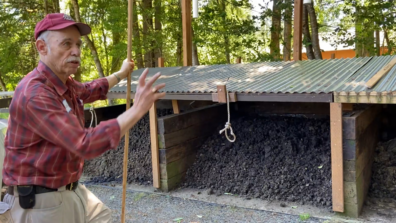 Local Resident talking in front of their 3-bin livestock manure compost system