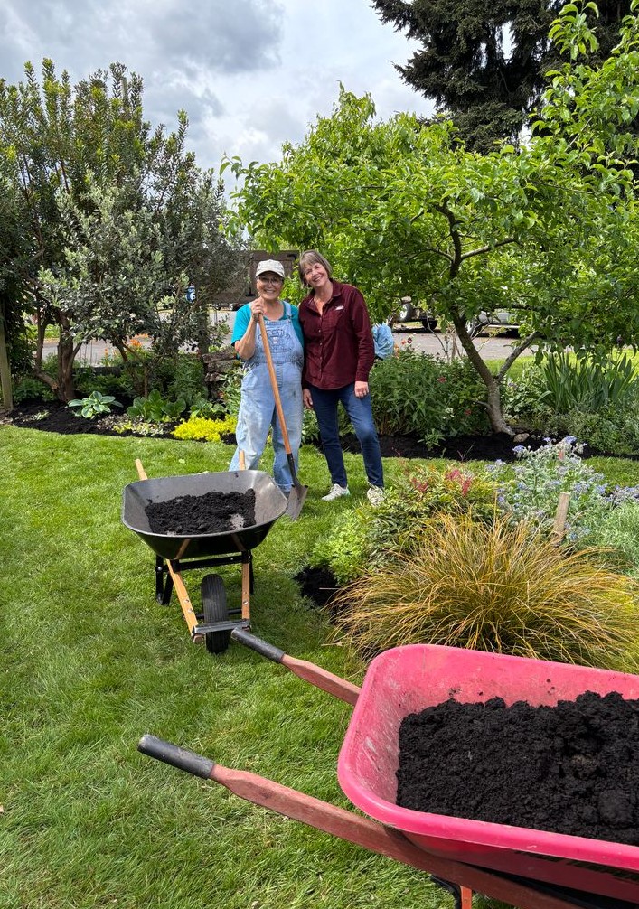 Master gardeners working in the flower beds.